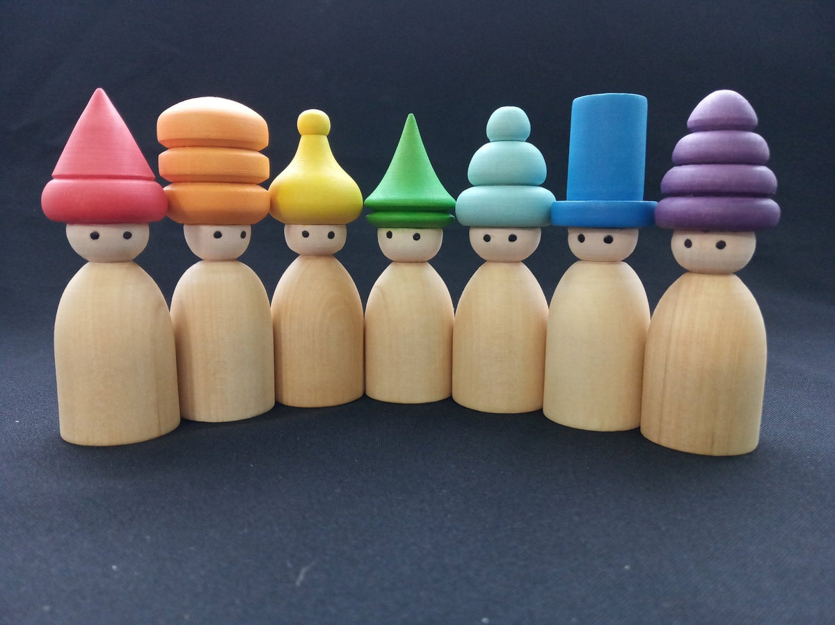 Wooden peg doll figures with rainbow-colored hats