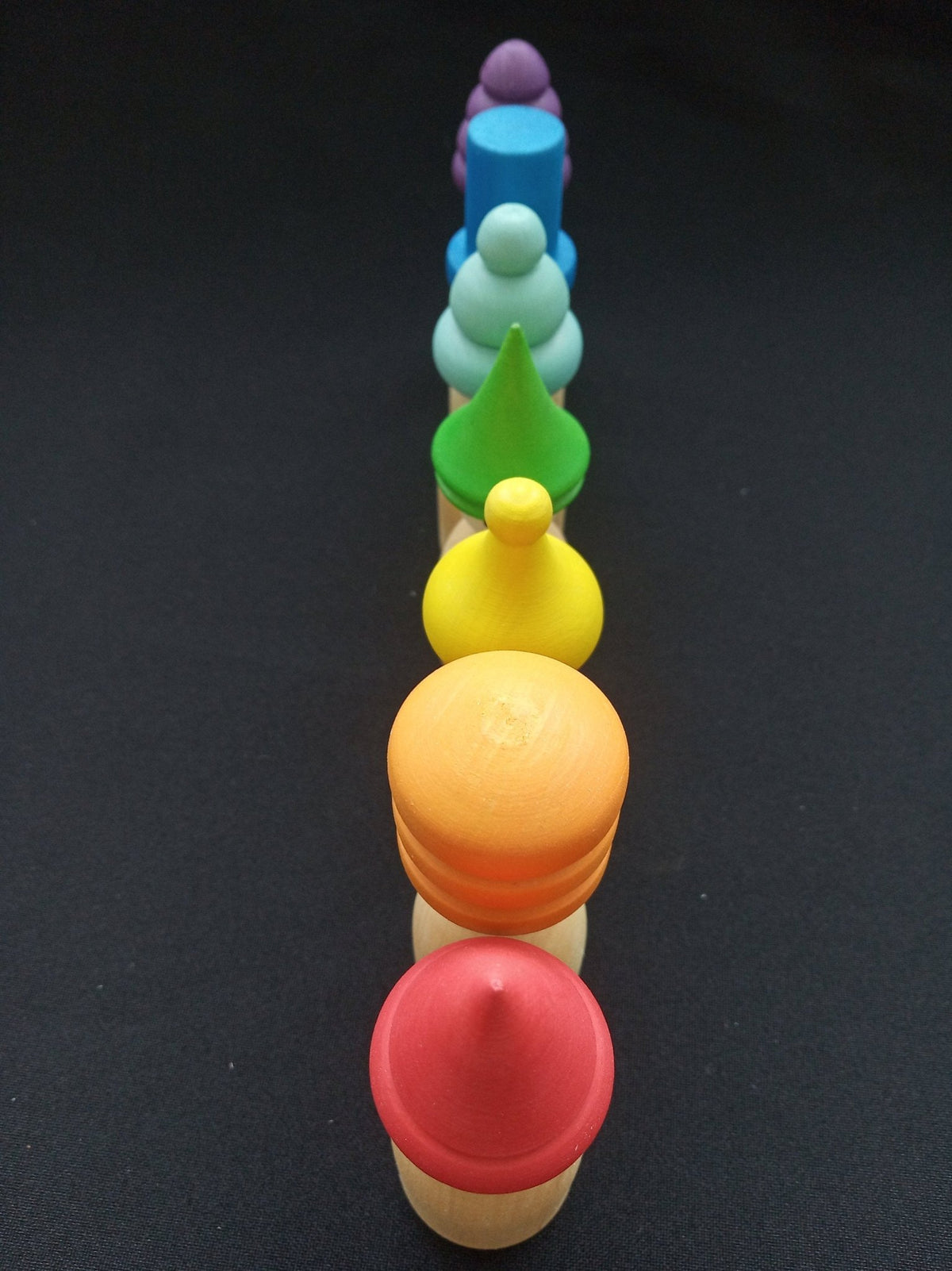 Colorful wooden peg dolls with hats
