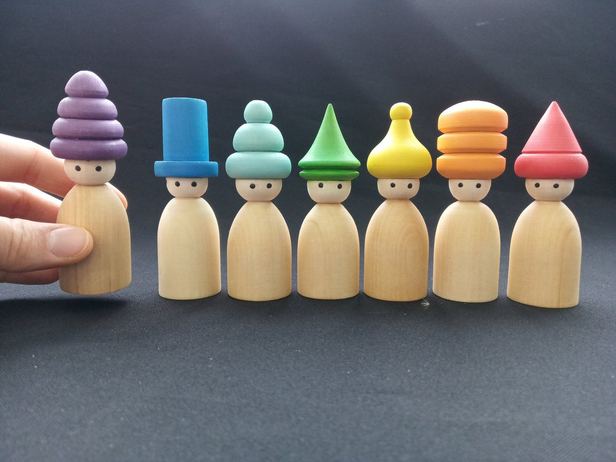 Colorful wooden peg dolls with hats