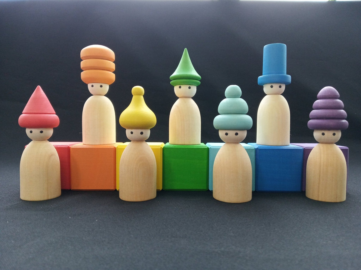 Wooden peg doll figures with rainbow-colored hats