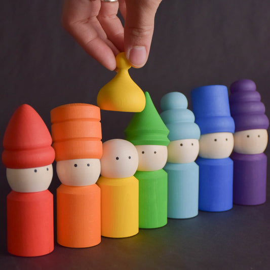 Rainbow wooden peg dolls with removable colored hats