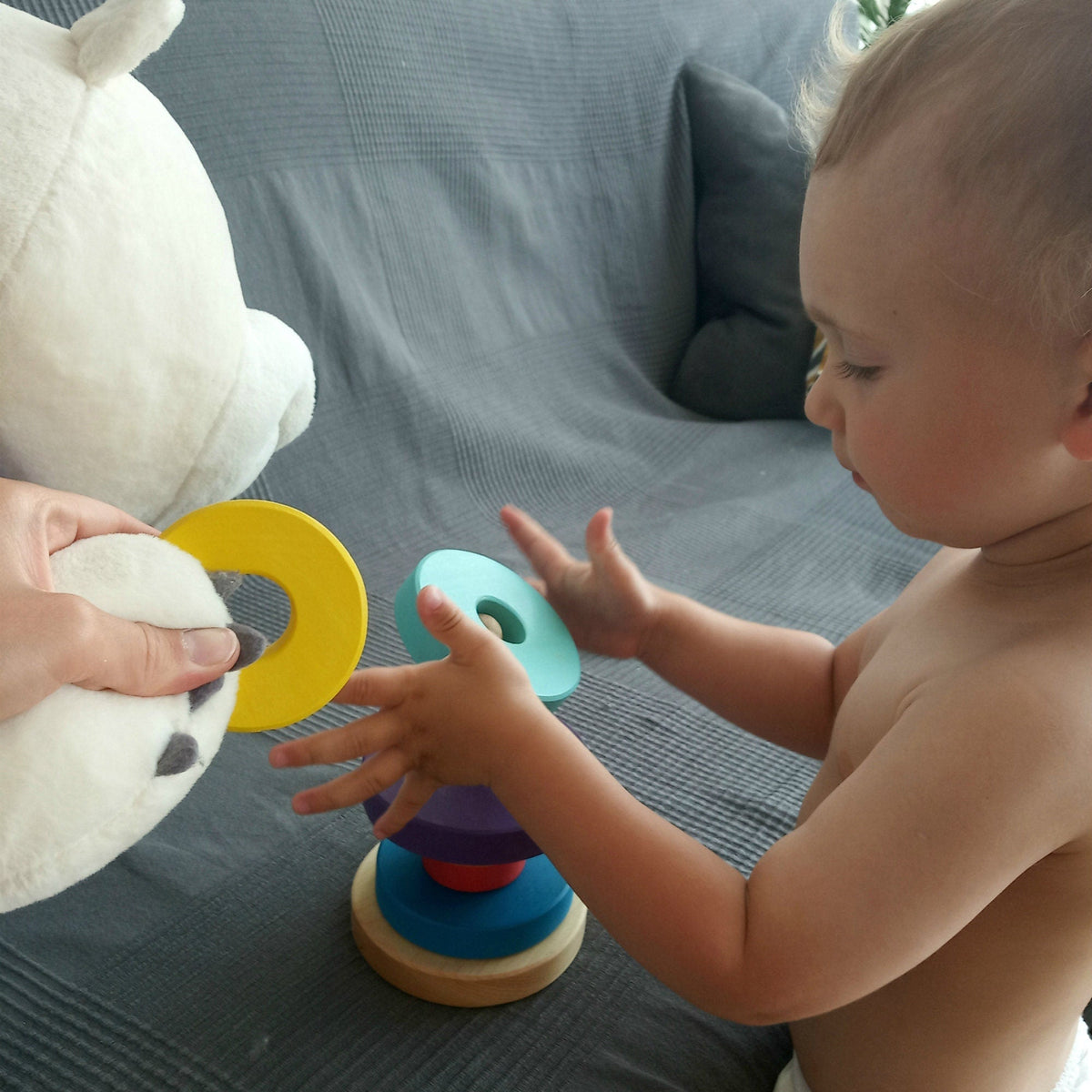 Ring stacking toy made from linden wood, with rainbow-colored rings