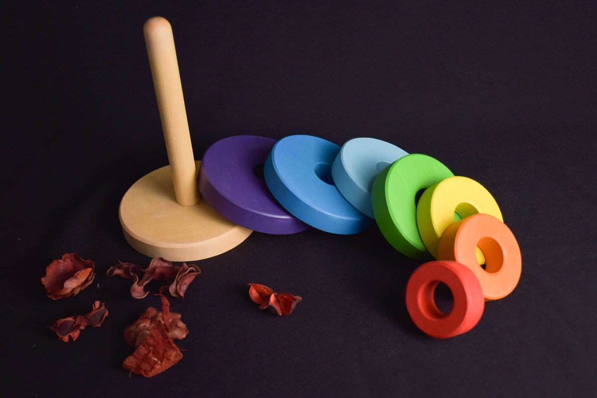 Linden wood stacking toy with rainbow-colored rings