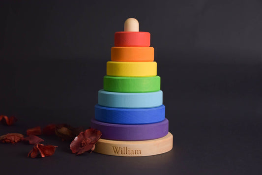 Linden wood stacking toy with rainbow-colored rings