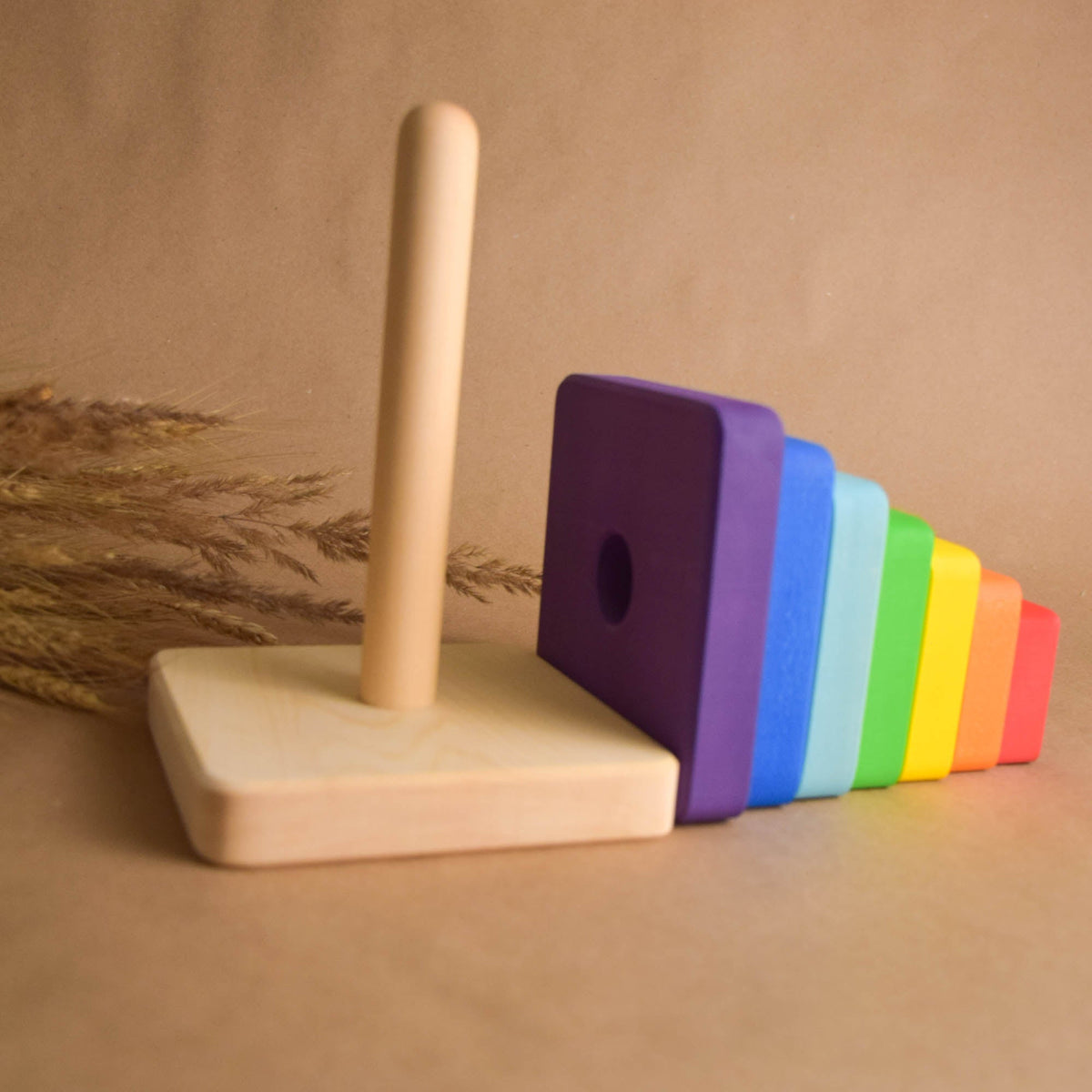 Stacking toy with square rings made from linden wood