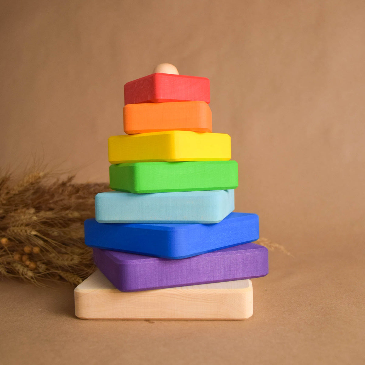 Stacking toy with square rings made from linden wood