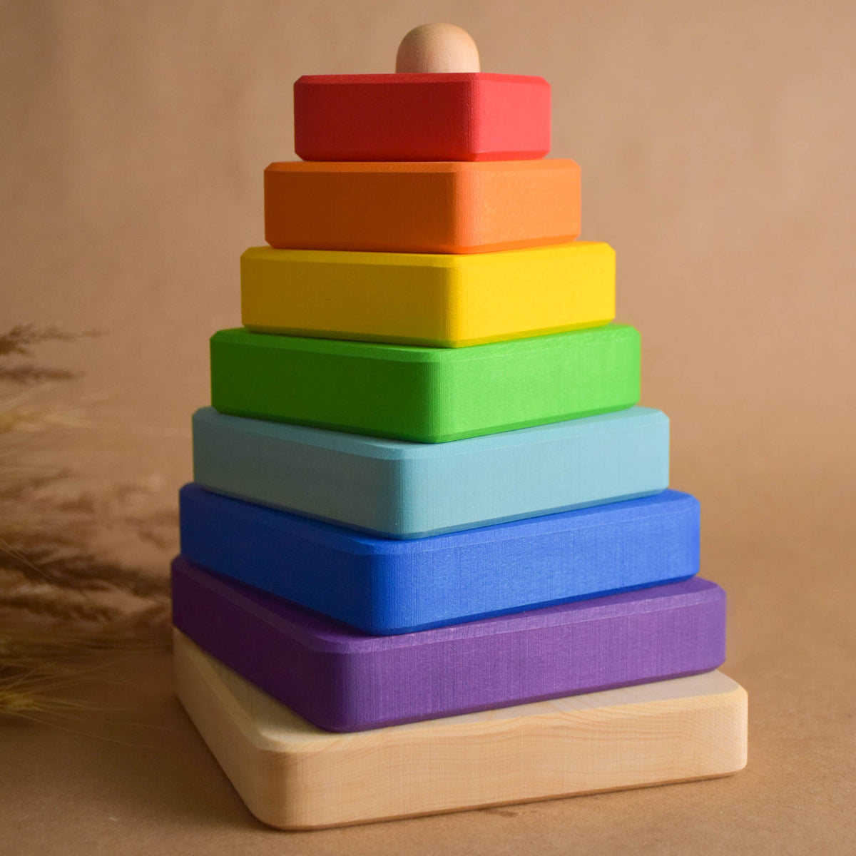 Ring stacking toy made from linden wood, with square rings