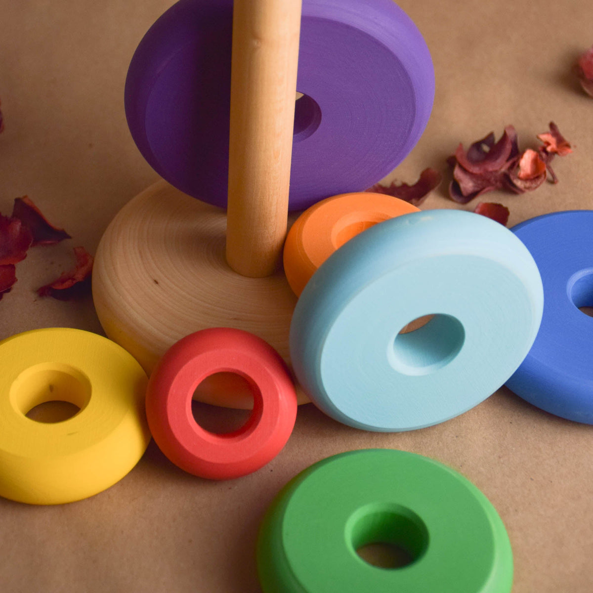 Ring stacking toy made from wood, with turned rings