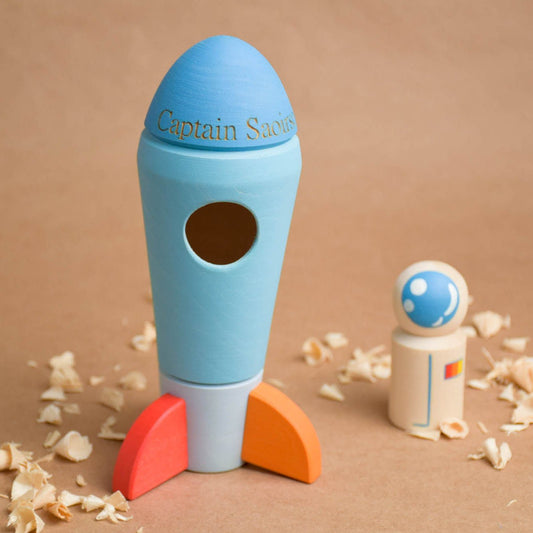 Linden wood toy rocket with an astronaut peg doll