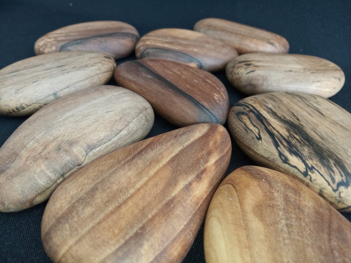 Pebble-shaped stacking blocks made from walnut wood